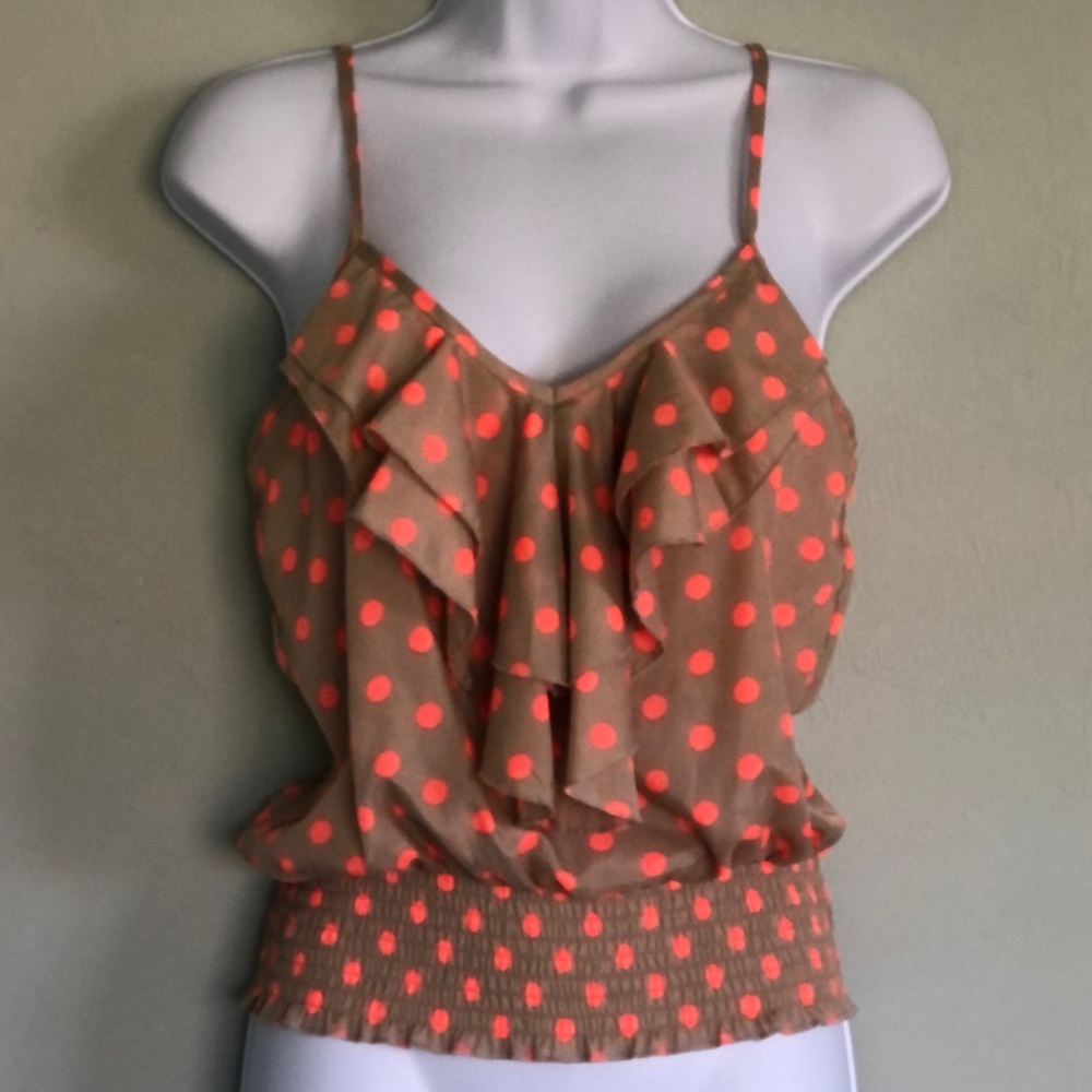 About a girl polk a dot tank top with ruffle